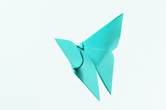 A light blue butterfly made out of paper