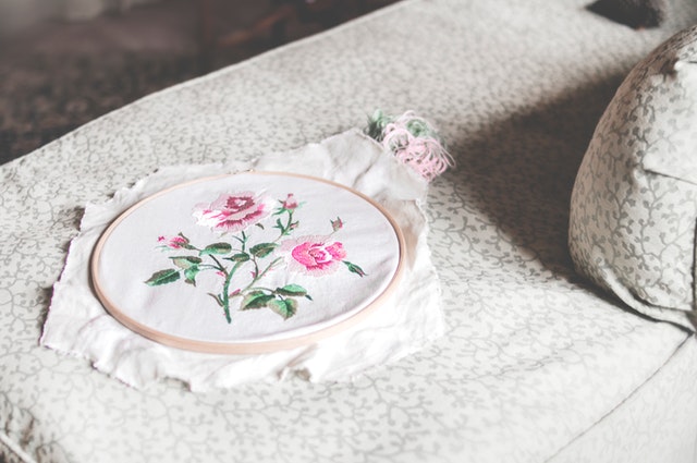 An embrodiered floral design on a white textile