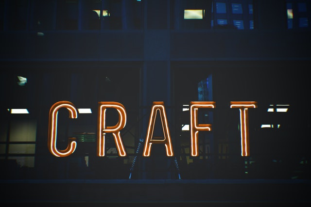 a red and white neon sign saying CRAFT